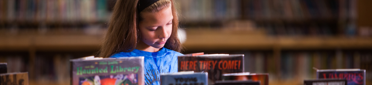 girl looking at books  